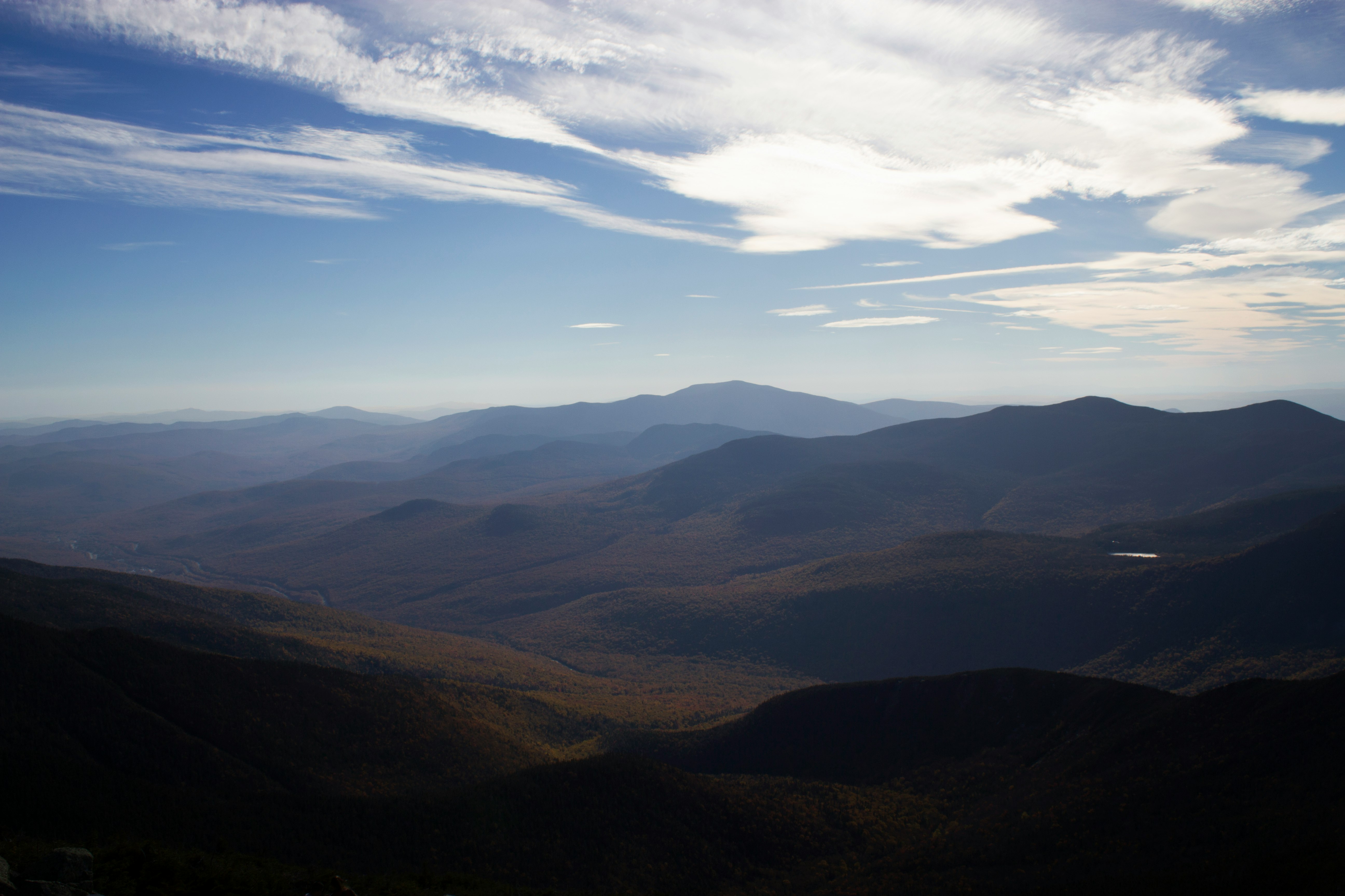 aerial view of mountains under cloudy sky